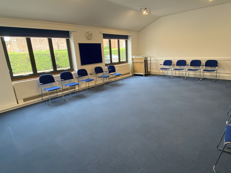 Carey Room - tables stored in corner. 12 chairs in room with more available close by as required.