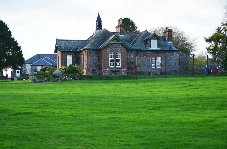 Hall with sports field next to it