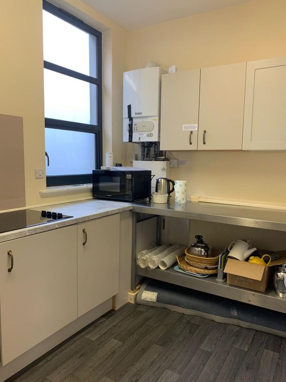 Kitchen with hob, microwave, fridge and kettle