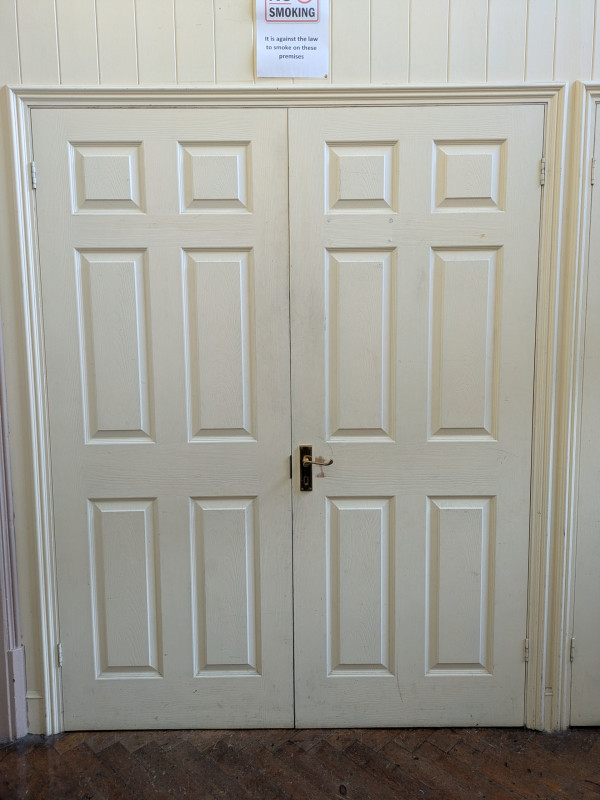 Cupboard in ante room where chairs and broom etc are stored
